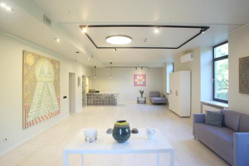 a living room with a couch and a vase on a table at VEPA in Vepriai