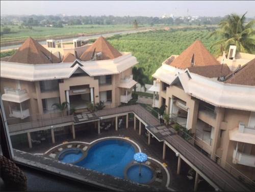 an aerial view of a building with a swimming pool at Royal Orchid Central Kireeti Hampi, Hospet in Hampi