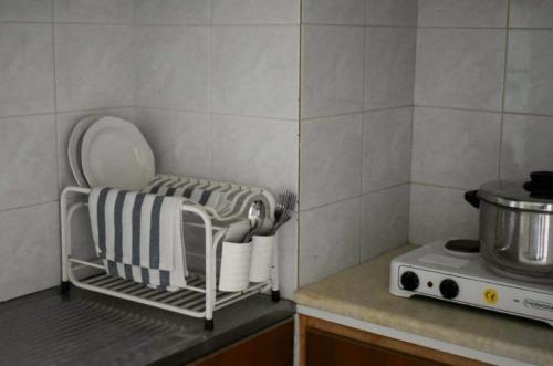 a kitchen with a drying rack on a counter at Poseidon Apartments in Gythio