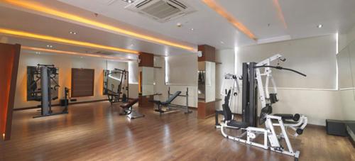a gym with several tread machines in a room at Royal Orchid Central Kireeti Hampi, Hospet in Hampi