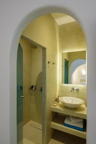 a bathroom with a sink and a shower at Mykonos Moussa in Agios Ioannis Mykonos