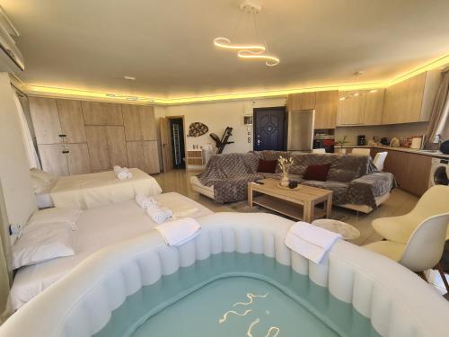 a living room with a pool in the middle of it at Sunny Home Private Jacuzzi Hydromassage, Fireplace, Acropolis & Lycabettus View, Underground Parking, 300m Metro Peristeri in Athens