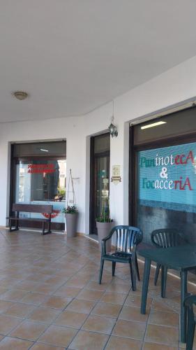 a restaurant with two chairs and a table and a window at Casa GIO' GIO' Borgo San Basilio in Marina di Pisticci