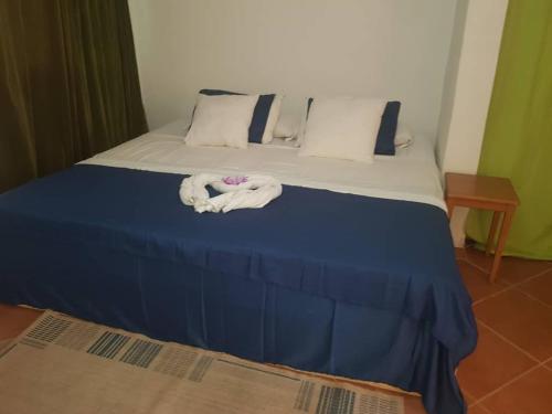 a bed with two towels on top of it at Poco Loco B&B in Abene