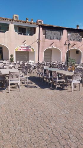 a group of tables and chairs in front of a building at Casa GIO' GIO' Borgo San Basilio in Marina di Pisticci