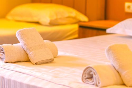a group of rolled up towels on a bed at Emily’s Hotel in Himare