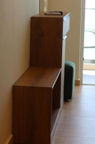 a wooden book shelf in a room at Emily’s Hotel in Himare