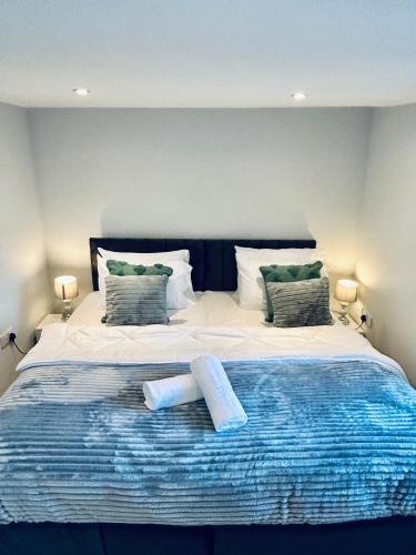 a bedroom with a large bed with two pillows at Folkestone Harbour 1 Bed Apartment F4 in Kent