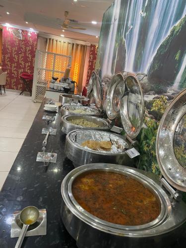 a buffet with many plates of food on a table at Hotel Seth Murlidhar Seva Sadan-Near Prem Mandir in Vrindāvan