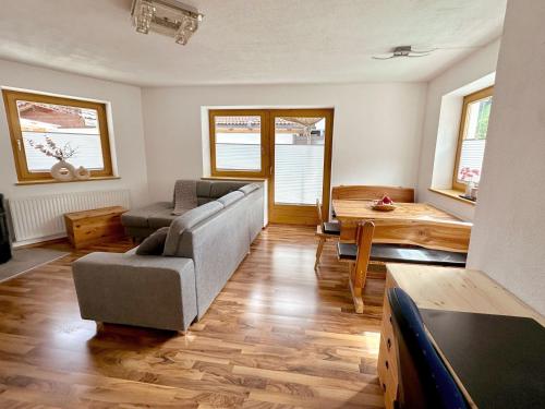 a living room with a couch and a table at Apartments Jessica Erdgeschoß & Kellergeschoß in Gries im Sellrain