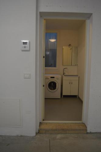 a kitchen with a washer and dryer in a room at Villa Artemia in Manerba del Garda