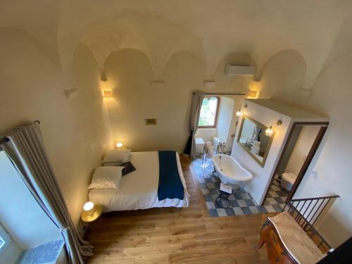 a bedroom with a bed and a sink and a mirror at Torra di Ciocce in Pino