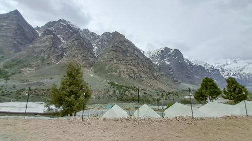 a group of tents in front of a mountain at Camp Paramount Journeys in Jispa