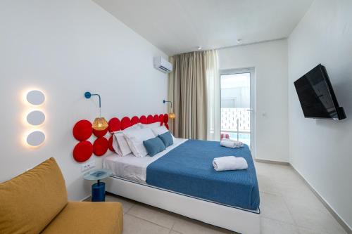 a bedroom with a large bed and a couch at Patricia Suites in Faliraki