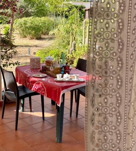 a table with a red table cloth on it at La Beata Giovanna in Mesagne