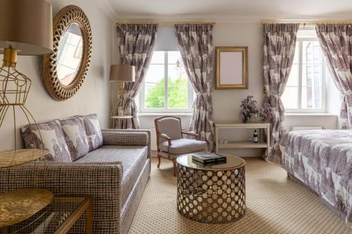 a living room with a bed and a couch at NARUTIS Hotel - Small Luxury Hotels of The World in Vilnius