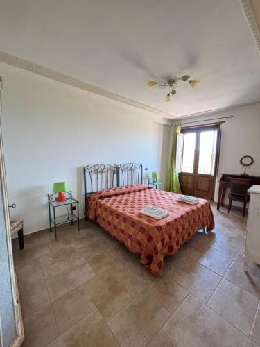 a bedroom with a bed with a red blanket on it at Il Borgo & il Feudo in Badolato