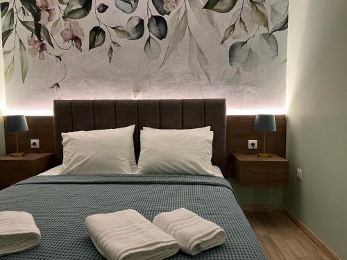 a bedroom with a bed with two towels on it at Oasis Apartment 1 by GG in Alexandroupoli