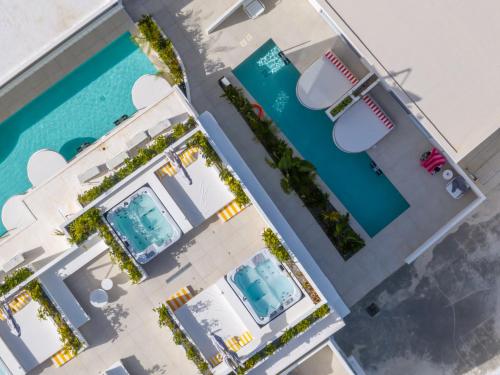 an overhead view of two swimming pools in aominium at Patricia Suites in Faliraki