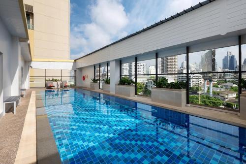 a swimming pool on the roof of a building at Citadines Sukhumvit 16 Bangkok in Bangkok