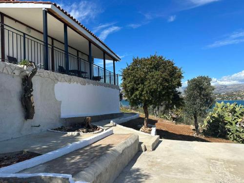 a house with steps leading up to the side of it at Ferienhaus Sunshine in der nähe vom Meer, free Parking, Spacious in Áyios Yeóryios