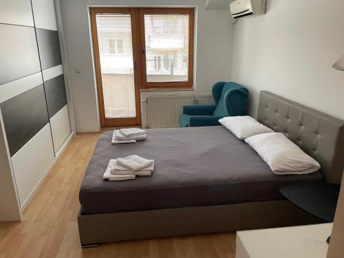 a bedroom with a bed with two towels on it at BT Lux apartment 2 in Skopje