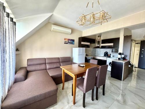 a living room with a couch and a table at Апартамент Свети Влас in Sveti Vlas