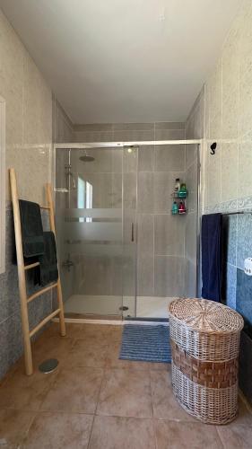 a bathroom with a shower with a glass door at Boutique Villa Jina, Private Pool, Mountain View, Near Nerja, Quiet Location, Mediterranean Garden in Torrox