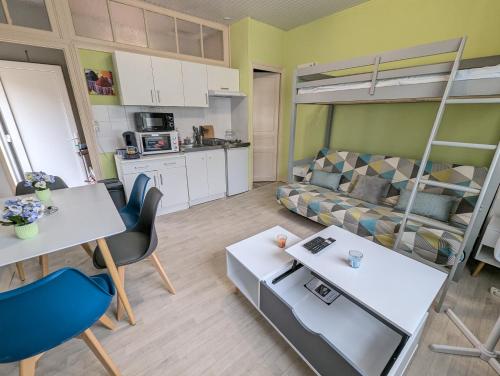 a living room with a couch and a loft bed at Grands Studios Maillochon accès Gare de Poitiers et Centre ville à Pieds in Poitiers