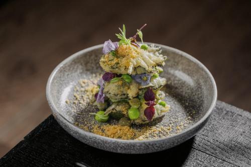 a bowl filled with food on top of a table at Hotel Munten in Weert