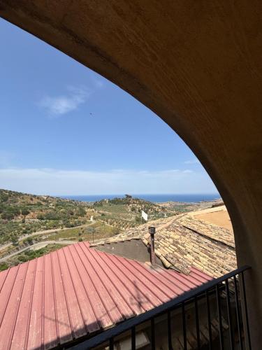 a view of the ocean from a building with a red roof at Il Borgo & il Feudo in Badolato