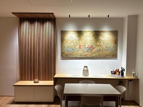 a dining room with a table and a painting on the wall at Casa Vacanze Nonna Grazia in Marsala