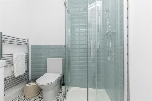 a bathroom with a toilet and a glass shower at Luxurious Apartment in Bournemouth