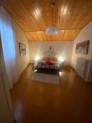a bedroom with a bed and a wooden ceiling at La Casa di Rita in Fogliano