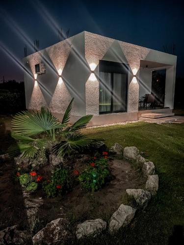a house with lights on the side of it at Casa Nita in Ulcinj