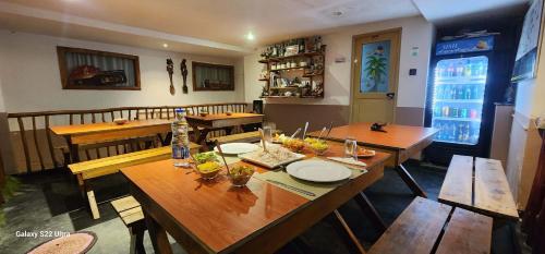 a dining room with wooden tables and chairs at Rainbow Sky Cottage in Ella