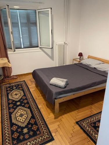 a bedroom with a bed and two rugs at Plaka quiet Apartment in Athens