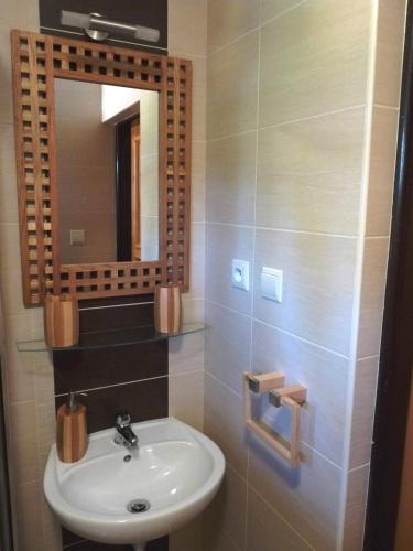 a bathroom with a sink and a mirror at Chata IVA in Oščadnica