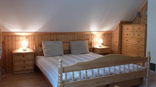 a bedroom with a large bed with two night stands at Chata IVA in Oščadnica