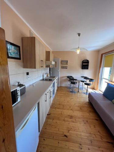 a kitchen with a couch and a table in a room at Willa Zuza in Kołobrzeg