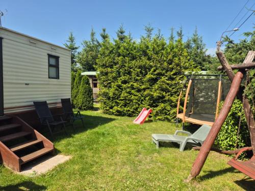 a yard with a swing and a playground at Abi in Zalewo