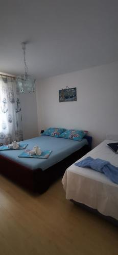two beds sitting next to each other in a room at Apartment Eden in Crikvenica