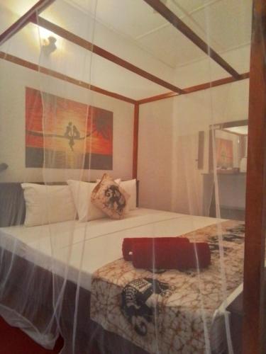a glass display of a bedroom with a bed at Villa Sunny Days in Hikkaduwa