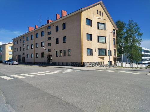 a large building on the side of a street at Cozy Apartment by the Sea 2 Rooms Free private parking in Kemi