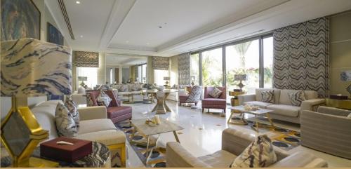 a large living room with couches and tables at Vivienda Hotel Villas, Jeddah in Jeddah