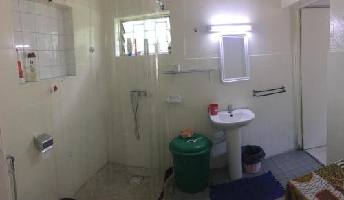 a small bathroom with a sink and a shower at Farida Lodge in Moroni
