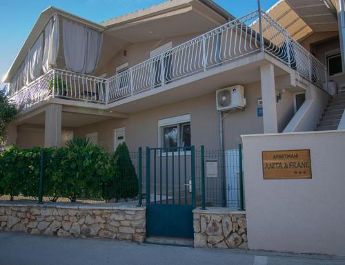 a building with a fence with a balcony on it at Apartments Anita Frane in Vodice