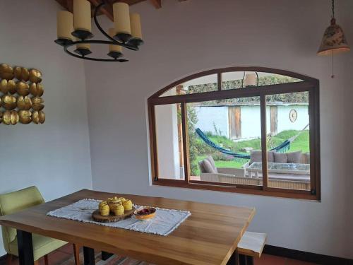 a dining room with a table and a window at Hacienda Otavalo Country Home in Otavalo