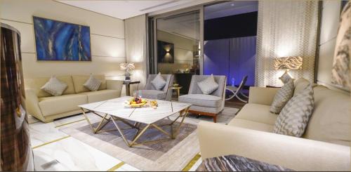 a living room with a couch and a table at Vivienda Hotel Villas, Jeddah in Jeddah