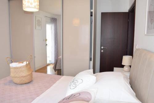 スタリグラードにあるApartman Gropaの白いベッド1台(バスケット付)が備わるベッドルーム1室が備わります。